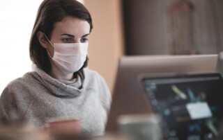 A Masked Woman Working at Office