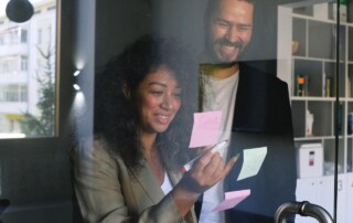 Colleagues Working on a Glass Board