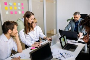 A team of colleagues working together in an office while discussing employee benefits plans