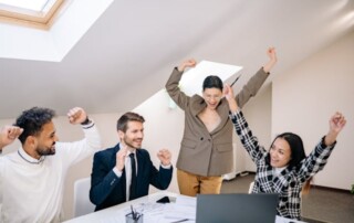 Diverse team celebrating success in an office