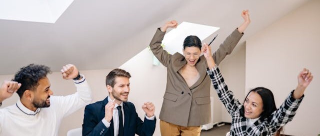 Diverse team celebrating success in an office
