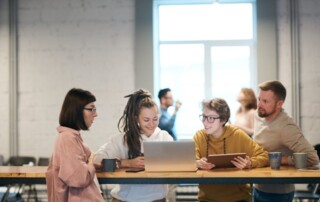 Group of employees discussing wellness initiatives in a modern office