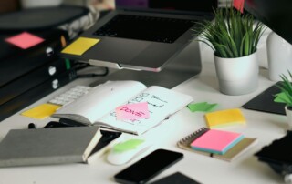 Compliance checklist on an office desk with employee benefits documents, notes, and administrative paperwork highlighting the importance of ACA, ERISA, and COBRA compliance for employers.