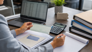 Employer reviewing an MLR rebate check with calculator and Pennsylvania documents.